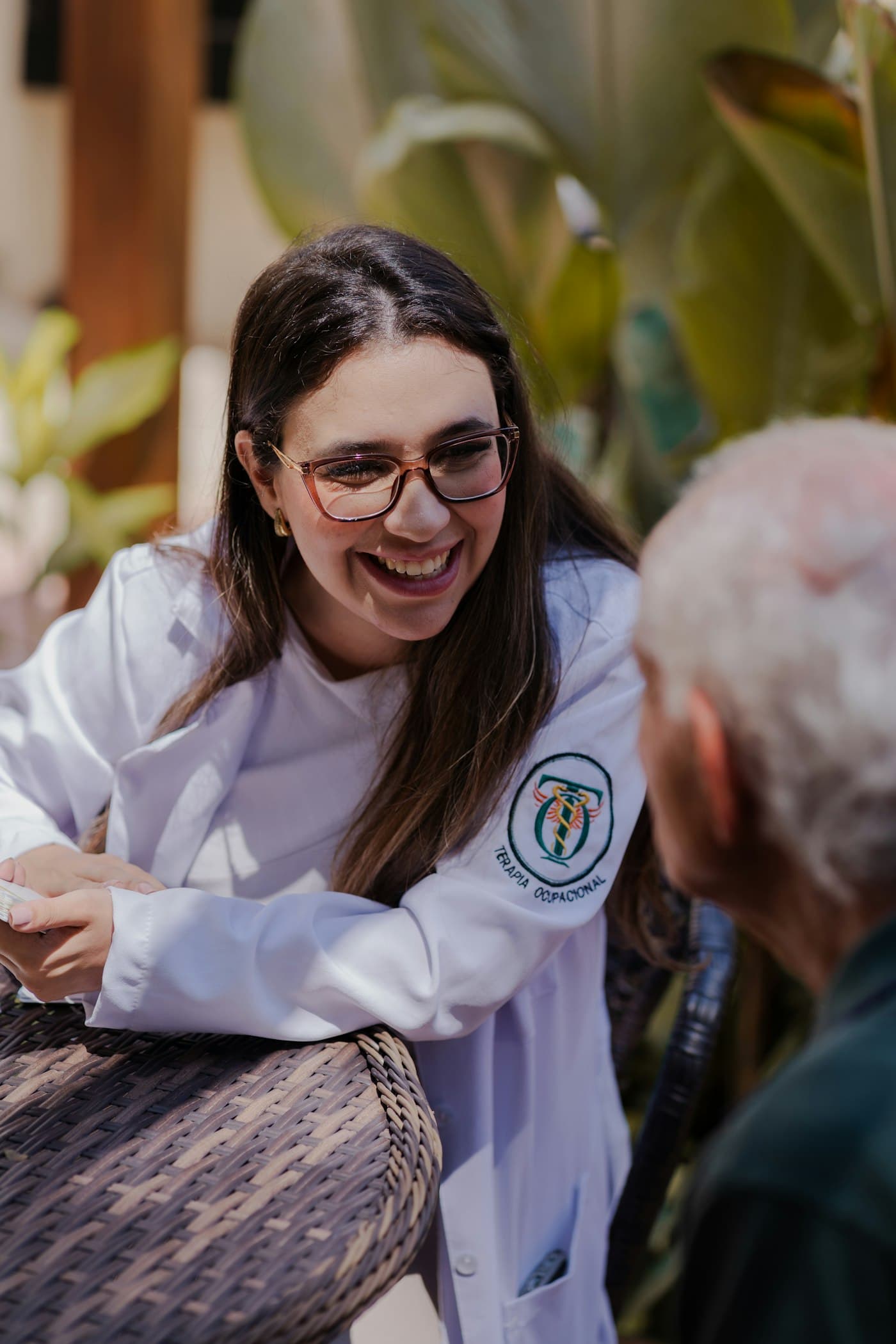 A doctor laughing with an older patient